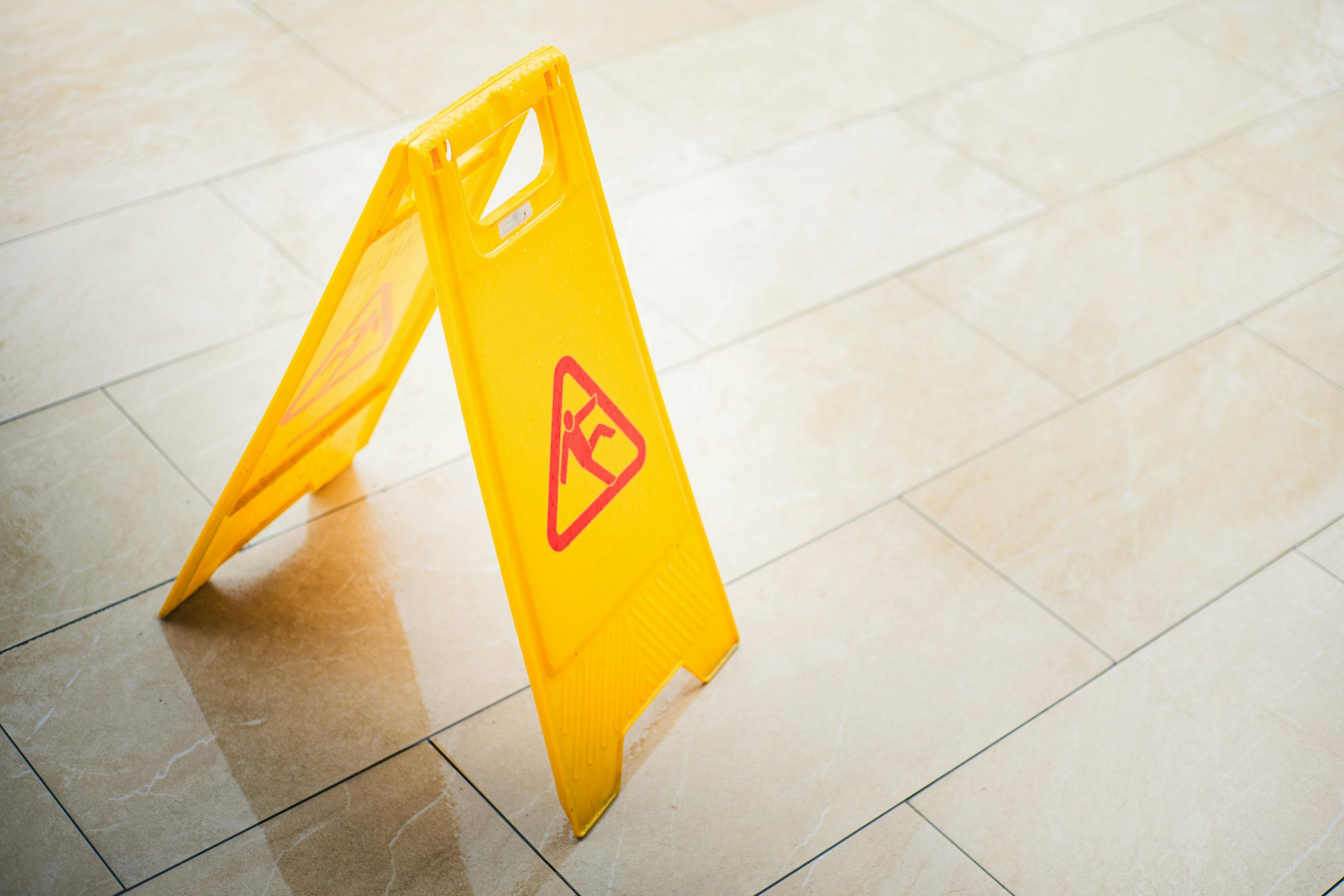 A-frame sign with a graphic of a person slipping